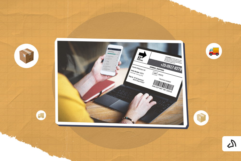 A person is holding a mobile device while using their laptop