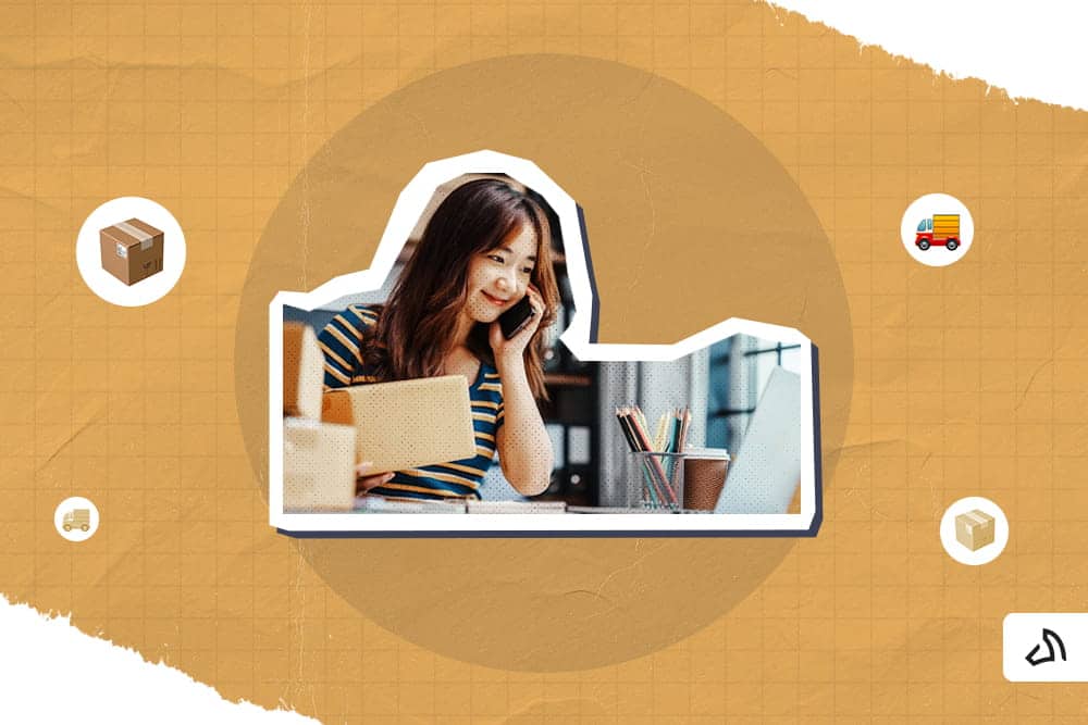 A woman talking on the phone while holding a box